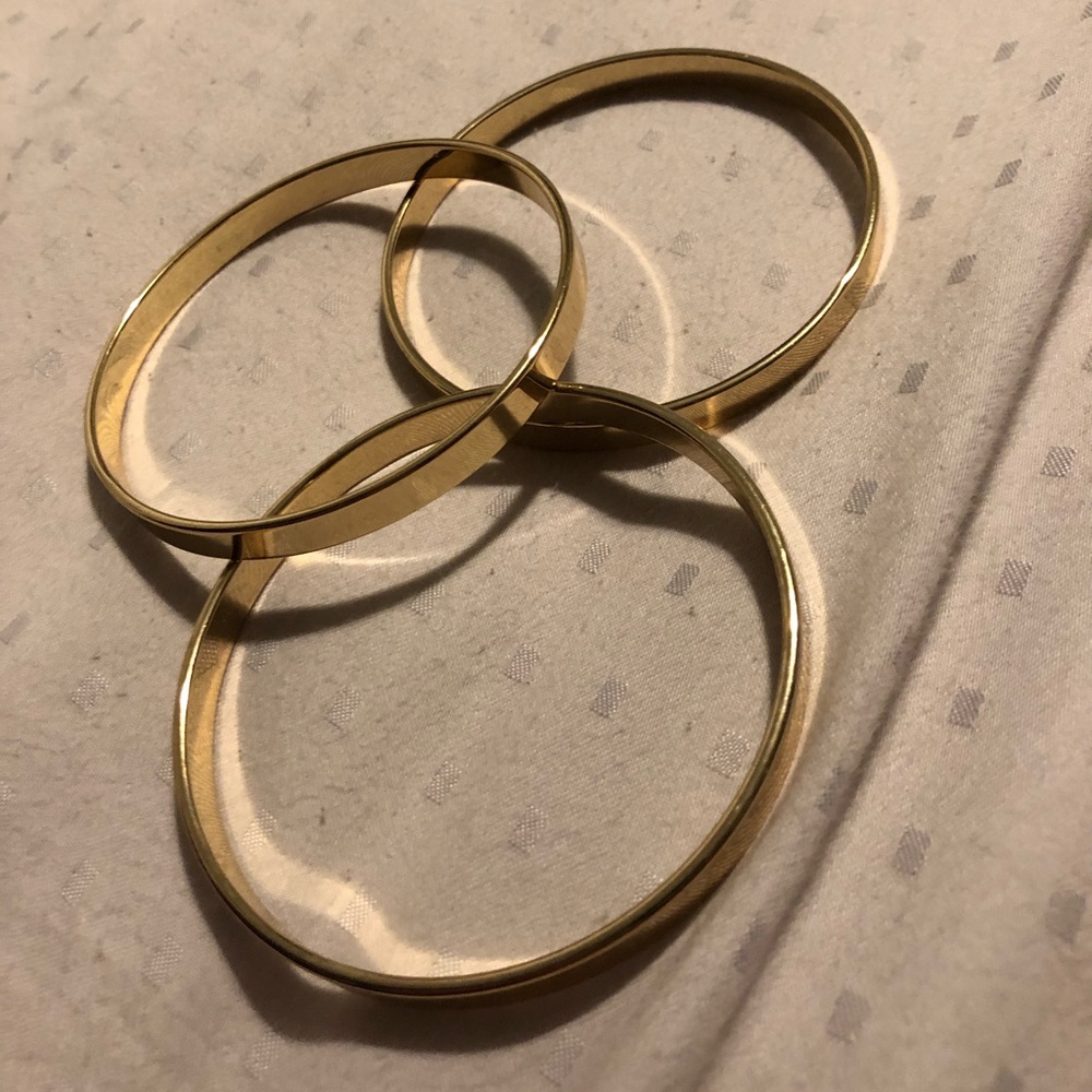 Three gold band bracelets